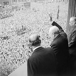 Churchill waving the Victory sign to the crowd in Whitehall on the day he broadcast to the nation that the war with Germany had been won, 8 May 1945.