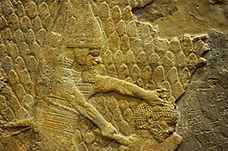 Relief of Sennacherib, depicting an Assyrian soldier beheading a prisoner