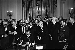 Lyndon B. Johnson signs the historic Civil Rights Act of 1964