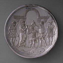 Silver plate showing the arming of David, made after the conclusion of the war in 629–630. The plate, using the costumes of the early Byzantine court, suggests that, like Saul and David, the Byzantine emperor was a ruler chosen by God.[197]