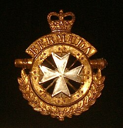 The badge of the British Army's Bermuda Regiment combines the eight-pointed cross of rifle regiments with elements from that of the Royal Artillery.