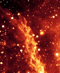 An artificial color image of the Double Helix Nebula, thought to be generated at the galactic center by magnetic torsion 1000 times greater than the Sun's.