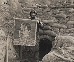 U.S. Marine with image of Stalin found in a bunker near Yudam-ni during Battle of the Chosin Reservoir, 27 November 1950