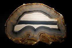 Agate with level banding in the center surrounded by layers of wall banding