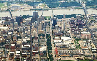 This aerial image of St. Louis, Missouri, shows the urban tree canopy of the central city, and the greenspace where the Gateway Arch is located.