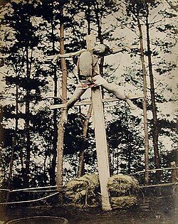 Early Meiji period crucifixion (c. 1865–1868), Yokohama, Japan. A 25-year-old servant, Sokichi, was executed by crucifixion for murdering his employer's son during the course of a robbery. He was affixed by tying to a stake with two cross-pieces.[107][108]