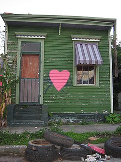 A modest shotgun house in New Orleans's Bayou Saint John neighborhood shortly after Hurricane Katrina. Shotgun houses consist of three to five rooms in a row with no hallways and have a narrow, rectangular structure.
