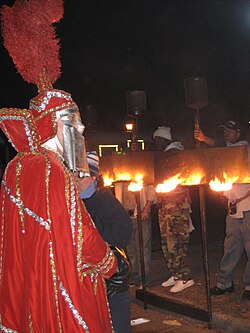 Carriers with lit flambeaux on Napoleon Avenue, just before the start of a parade, 2007