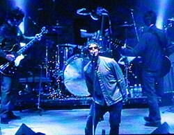 Oasis playing live. NME states, "as (What's the Story) Morning Glory? emerged to colossal sales, it became clear that while Blur had won the battle, Oasis were winning the war."[50]