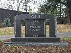 Ali's headstone, with an inscription of his quote: "Service to others is the rent you pay for your room in heaven"
