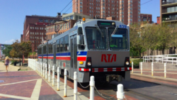 An RTA train approaches Settlers Landing station on the Waterfront Line