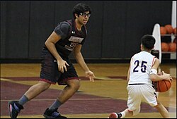 A photo taken during a high school basketball game in 2024. Demonstrates the extreme disparities in terms of physical maturity that can be seen between opposing players.