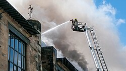SFRS firefighter douses flames at the Glasgow School of Art fire in May 2014