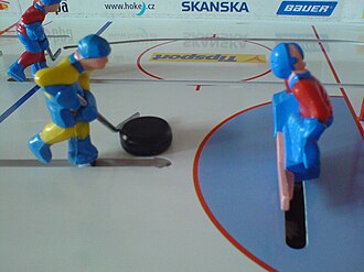 A player figure with puck.