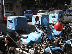 Domino's Pizza motor bikes that are used for pizza home delivery in Goa, India, with transport boxes mounted atop