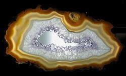Agate geode slice with macrocrystalline quartz and a hollow center