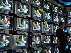 An electronics store displaying CRT TVs in a shopping mall in Jakarta, Indonesia (2002)