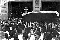 Quwatli's coffin being carried by mourners during his funeral procession at the Umayyad Mosque in Damascus