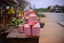 Red palm oil being sold on the roadside in plastic bottles in Ghana. Artisanal production of palm oil is common there, providing a key staple food stuff in most traditional cooking.