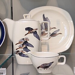 Three pieces of Midwinter Pottery 'Wild Geese' pattern tableware, with Scott's 1954 designs applied to "Stylecraft" shapes by Roy Midwinter, circa 1952, displayed in the Victoria and Albert Museum, London[22]