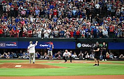 George W. Bush throwing a ceremonial first pitch to Iván Rodríguez prior to Game 1