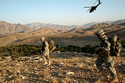 An Apache helicopter provides protection from the air, Lwar Kowndalan in Kandahar, 2005