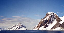 Booth Island and Mount Scott flank the narrow Lemaire Channel on the west side of the Antarctic Peninsula, 2001.