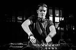 Black and white photo of Alesso as a DJ.
