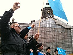 Uyghur protesters in Amsterdam in 2020 with the Flag of East Turkestan