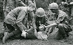 Two United States soldiers and a South Vietnamese soldier waterboard a captured North Vietnamese prisoner during the Vietnam War; the image, which appeared on the front cover of The Washington Post on January 21, 1968, led to the court-martial of a United States soldier, although The Washington Post described waterboarding as "fairly common".[132][133]