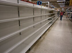 Empty shelves in a store in Venezuela due to shortages in 2014