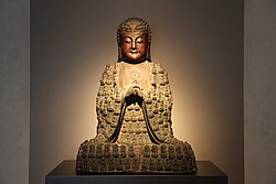A Ming Bronze of the supreme cosmic Buddha Vairocana ("The Illuminator"). The bronze depicts the cosmic body of Vairocana (which is equal to the universe itself) and also depicts the numerous manifestations (nirmanakayas) of Vairocana (the small Buddhas covering his body).