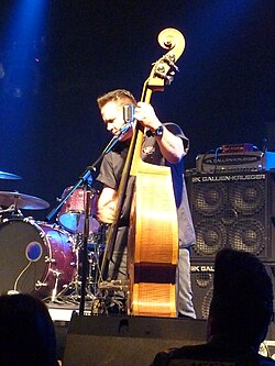 Psychobilly bassist Jimbo Wallace onstage with Reverend Horton Heat; note his large bass stack consisting of a 15-inch cabinet, a quadruple 10-inch cabinet, and an amplifier "head".