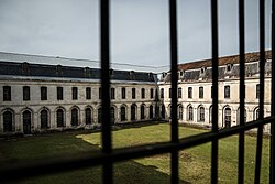In the modern era, many fortified buildings, such as abbeys and fortresses, were converted to use as prisons. Pictured is the cloister of Clairvaux Abbey, converted to a prison exercise yard after secularization.