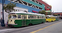 Three PCCs on the San Francisco Municipal Railway's F-line in 2003. Pictured are an example of one double-ended streetcar and two single-ended cars.