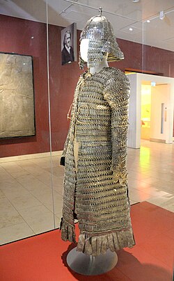 Lamellar coat and helmet. From Tibet, in modern-day China. 14th–17th century CE. Iron, leather, and textile. Presented by Lieutenant Colonel Sir Francis Younghusband. Discoveries Gallery, National Museum of Scotland