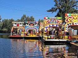 Trajineras in the canals of Xochimilco. Xochimilco and the historic center of Mexico City were declared a World Heritage Site in 1987.