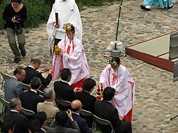 Miko performing a Shinto ceremony near the Kamo River