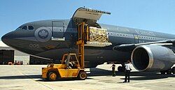 United States Navy personnel unload Canadian relief supplies from a Royal Canadian Air Force transport aircraft in Pensacola, Florida.