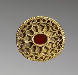 A Hunnish oval openwork fibula set with a carnelian and decorated with a geometric pattern of gold wire, 4th century, Walters Art Museum