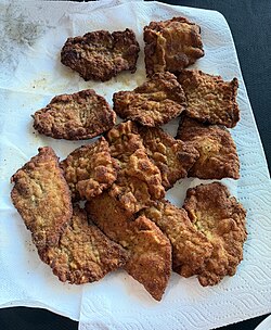 A tray of breaded veal cutlets