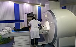 Patient being positioned for MR study of the head and abdomen