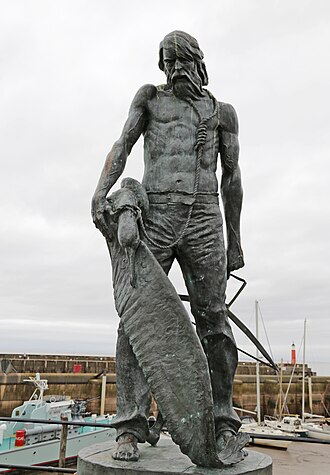 Commemorative statue at Watchet, Somerset: the albatross hangs on a rope looped around the ancient mariner's neck. "Ah! well a-day! what evil looks Had I from old and young! Instead of the cross, the Albatross About my neck was hung."[4]: lines 139–142