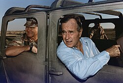 U.S. president George H. W. Bush riding in a Humvee with General Schwarzkopf in Saudi Arabia