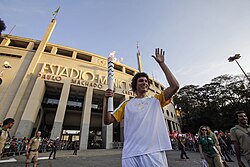 Basketball player Anderson Varejão carrying the torch in São Paulo