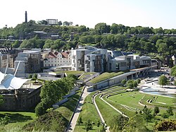 The Scottish Parliament Building with Calton Hill in the background