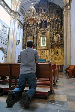 A Catholic prays in a church in Mexico.