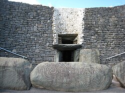 Newgrange entrance (partly reconstructed) and engraved stones, c. 3200 BC