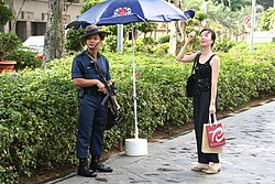 A trooper of the Gurkha Contingent of the Singapore Police Force gives directions to a civilian.
