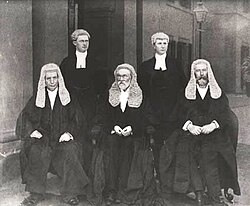 The first bench of the High Court: Barton, Griffith and O'Connor seated, with court officials in the background. Photo taken at the first sitting of the court on 6 October 1903.